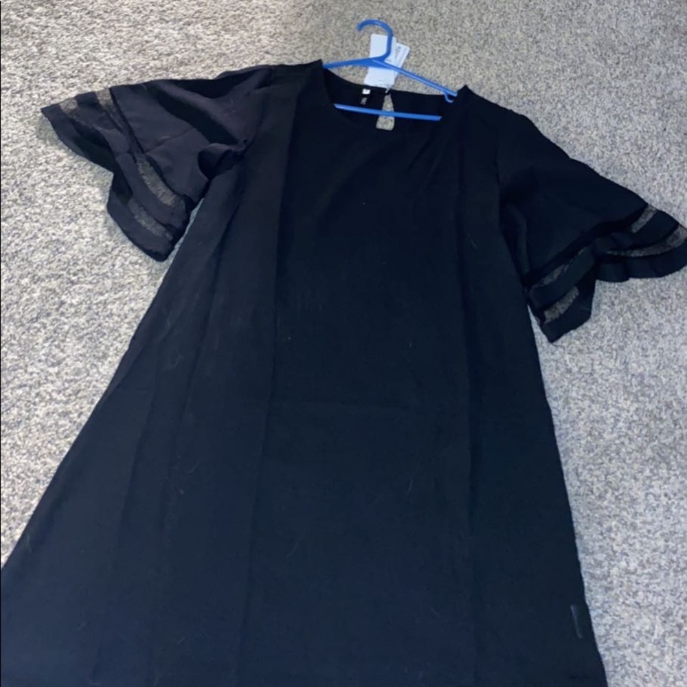 Short black dress with see through panels on sleeves